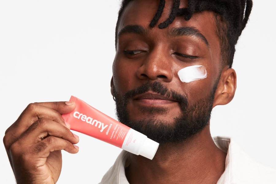 Homem segurando o Calming Cream.